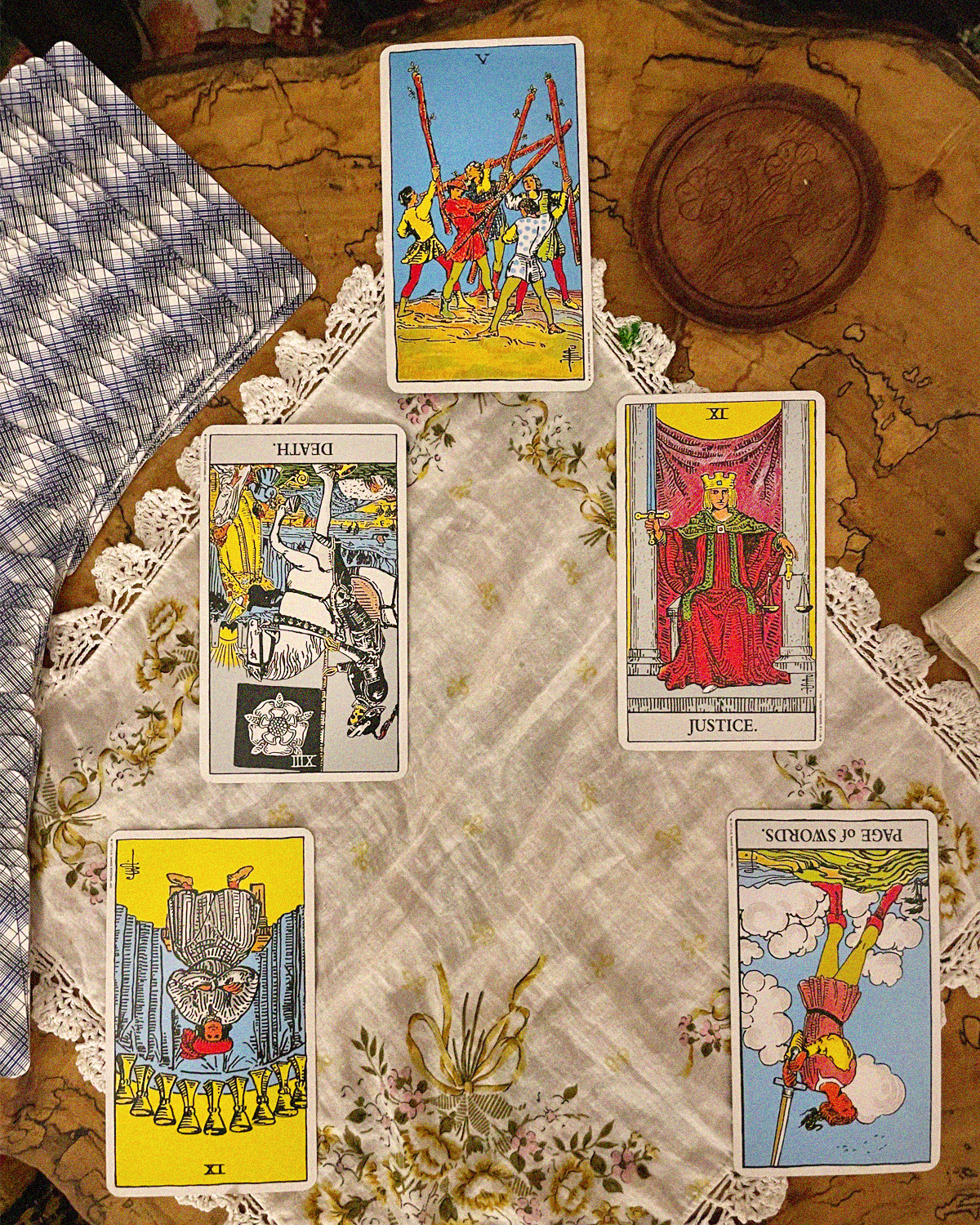 5 card tarot spread with Rider Waite Tarot Deck. In order from top to bottom: 5 of wands, Death Reversed, Justice, 9 of Cups Reversed, Page of Swords Reversed